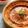 Muhammara in a bowl with Olive Oil drizzle.