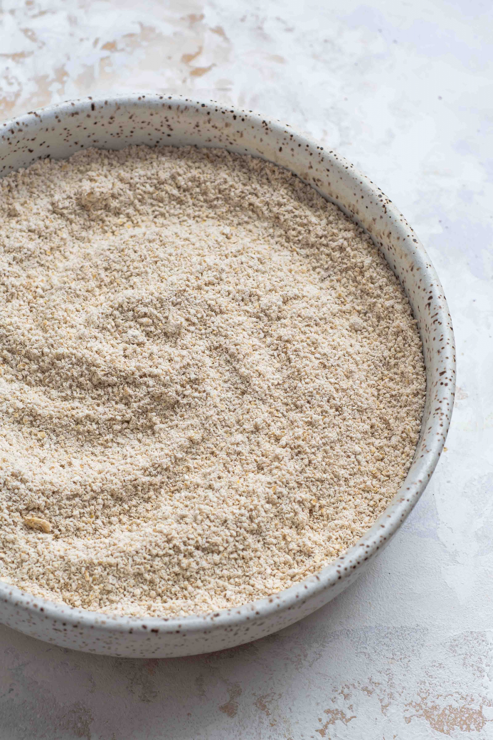 homemade oat flour in a ceramic bowl