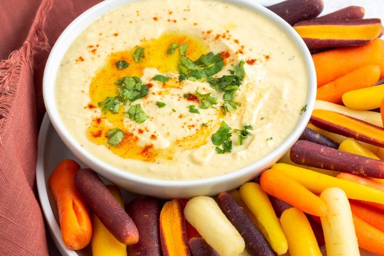 hummus in a plate with baby carrots