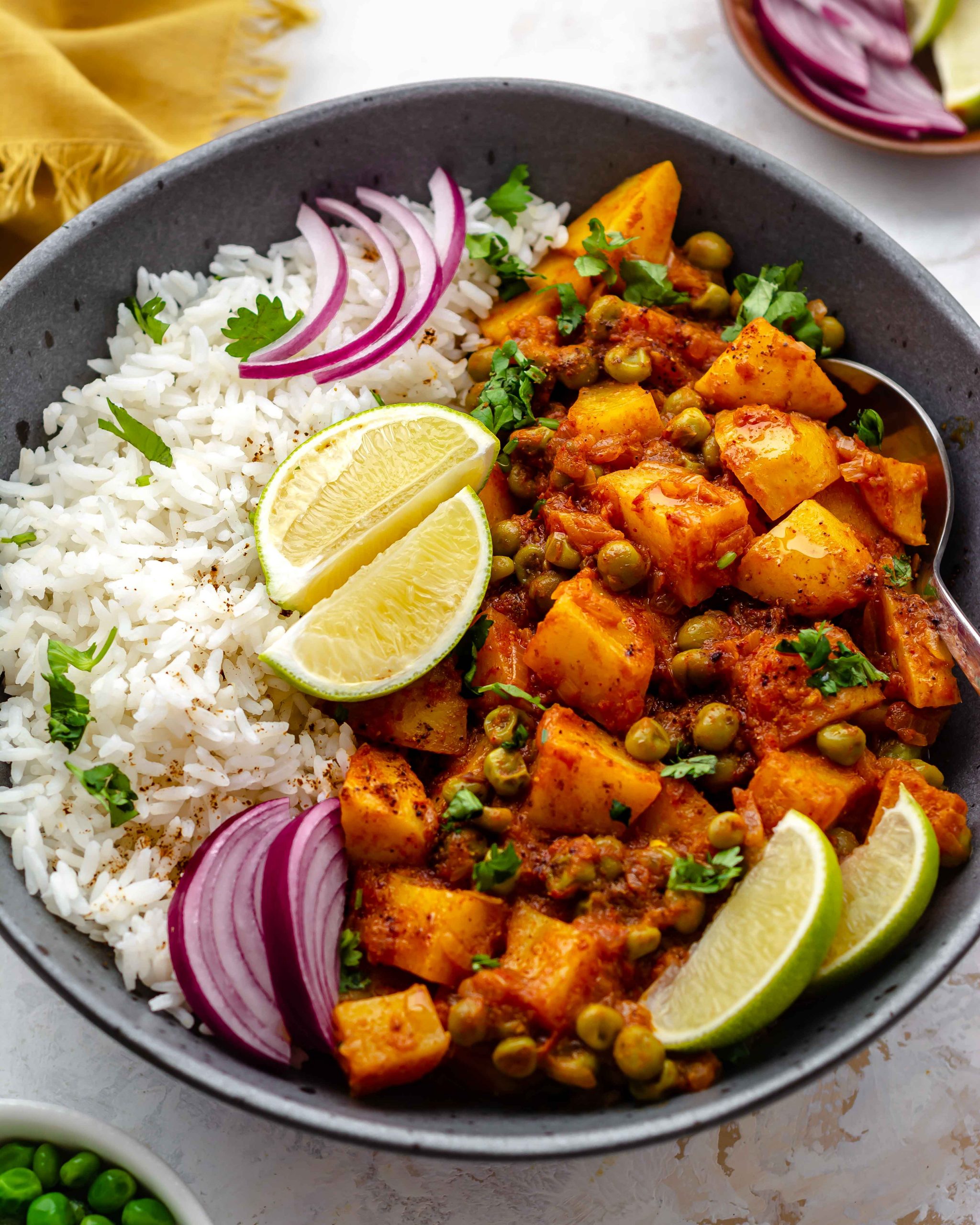 south indian potato and pea curry in a bowl with rice